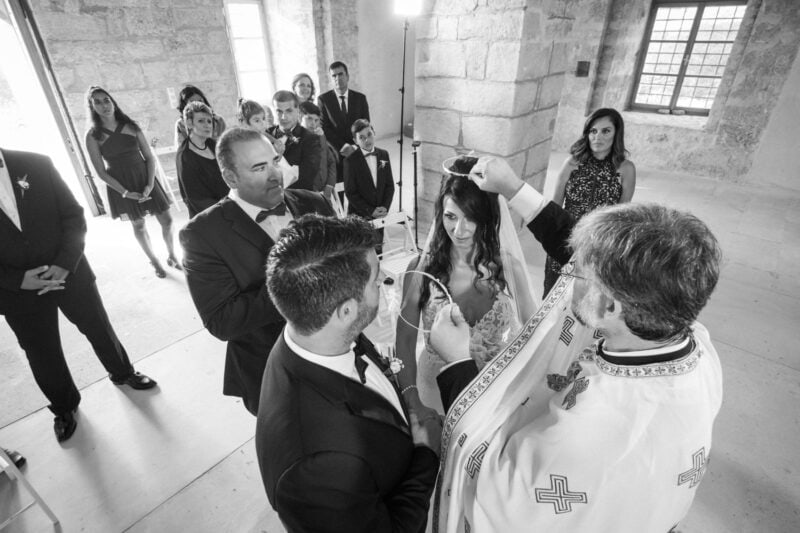Intimate wedding ceremony inside the church at Niokastro in Pylos