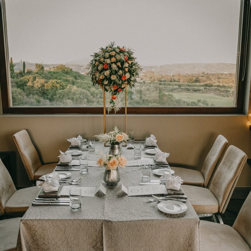 Wedding table decor overlooking the Messinian landscape at Costa Navarino