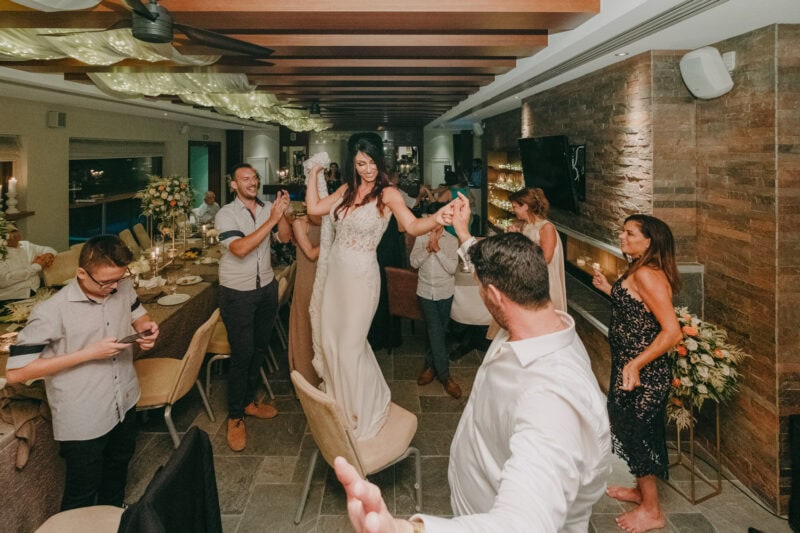 Bride dancing with guests at her destination wedding reception