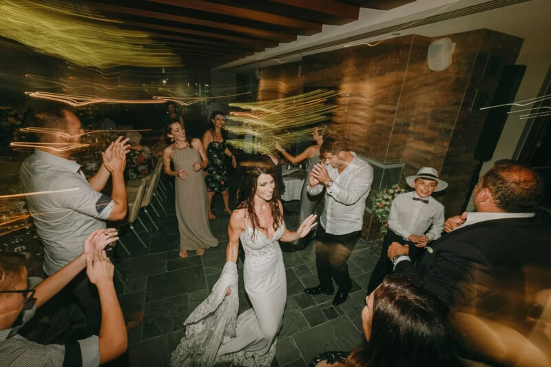 Bride and wedding guests dancing during the evening celebration