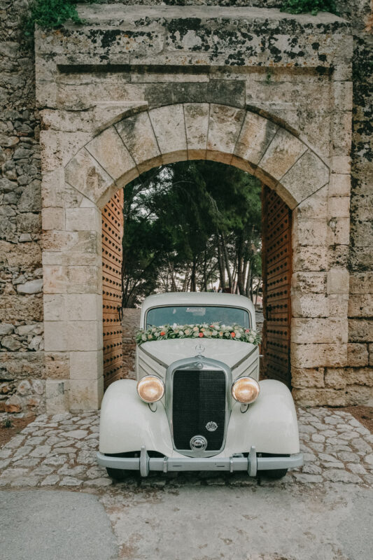 Vintage wedding car at the entrance of Niokastro Castle in Pylos
