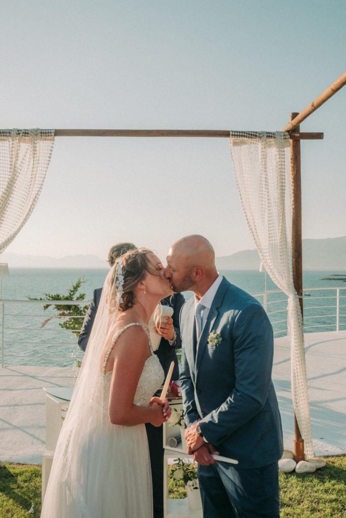Newlyweds kissing during their Akrotiri Venue wedding