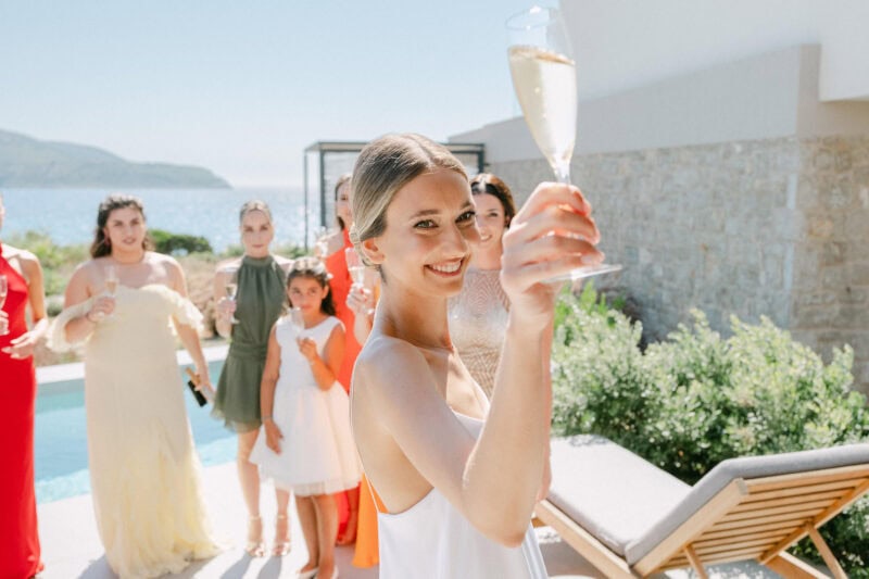 Woman celebrating with champagne at Antonis Panitsas event.