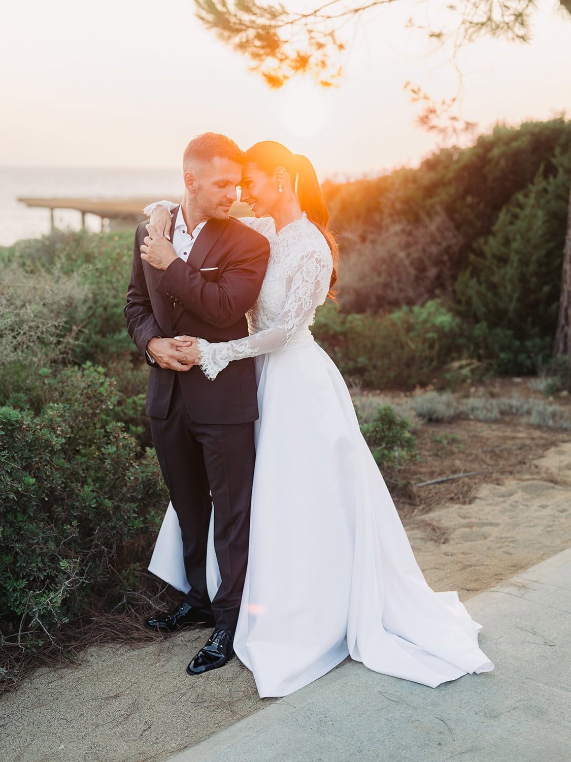 Wedding couple embracing at sunset at Costa Navarino in Messinia