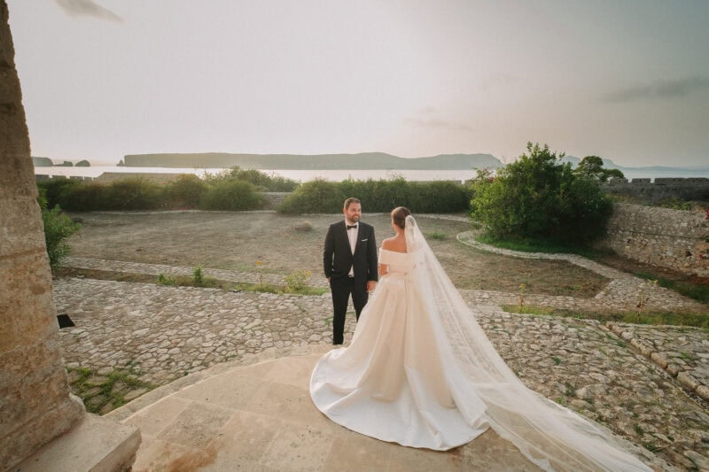 Wide portrait of the newlyweds surrounded by the historic landscape of Pylos