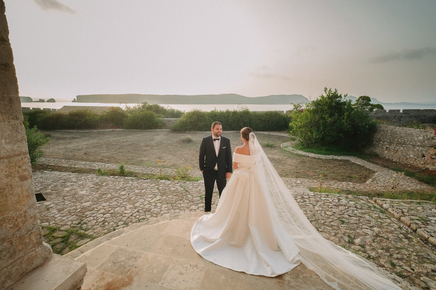 Wide portrait of the newlyweds surrounded by the historic landscape of Pylos