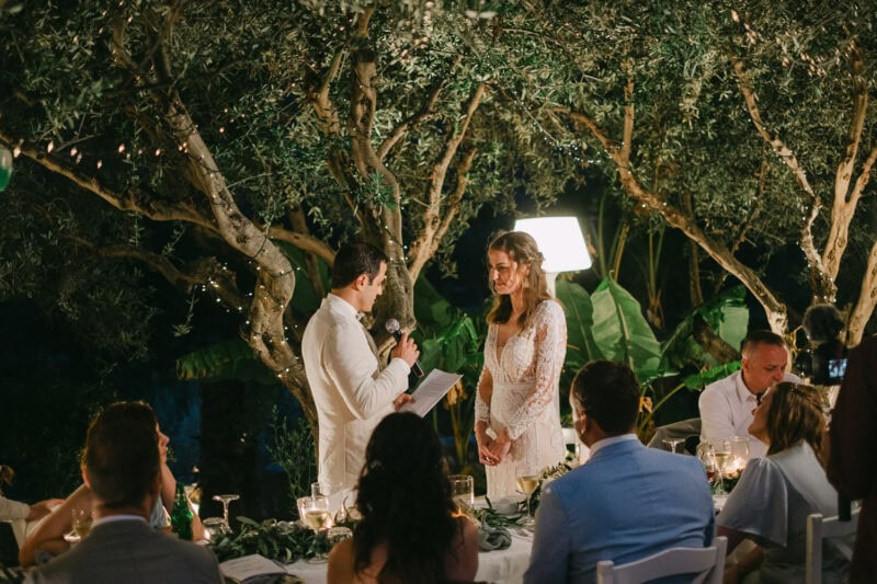 Bride and groom during evening wedding speeches in Mani