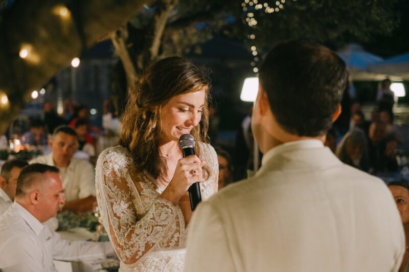 Bride giving a speech at her outdoor wedding reception