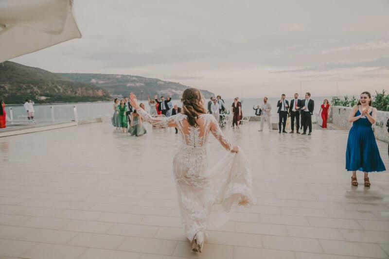 Bride arriving at the seaside wedding reception in Mani