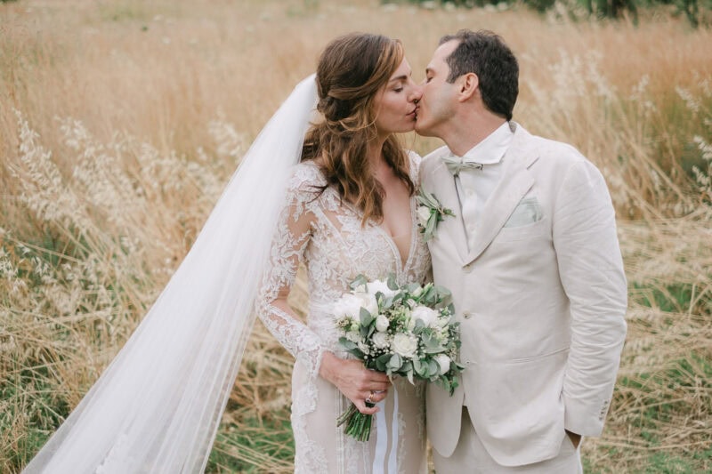Newlyweds kissing in the Mediterranean landscape of Mani Greece