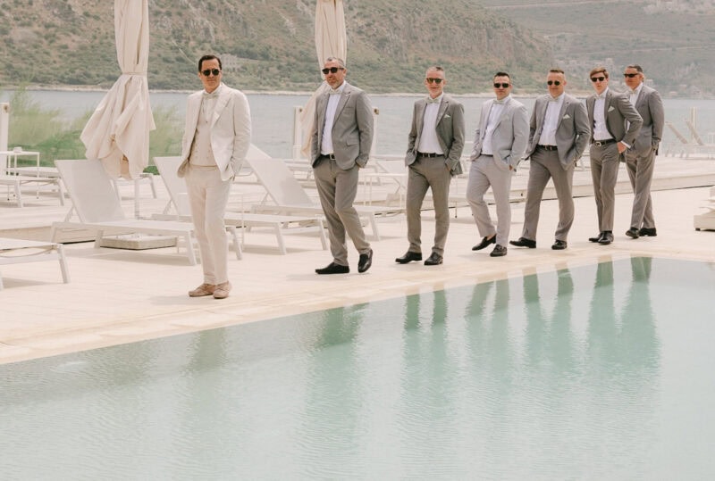 Groom and groomsmen walking beside the pool in Mani Greece