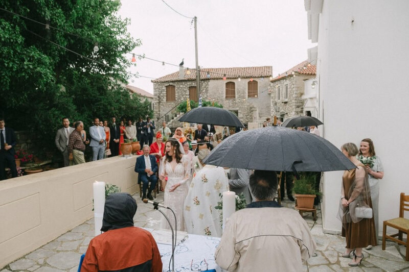 Rain during an outdoor wedding ceremony in Mani