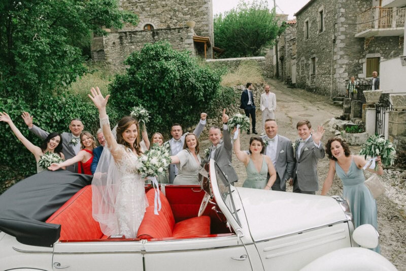 Bride and wedding party arriving at the ceremony in Mani
