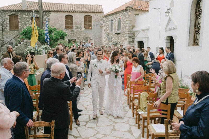 Bride and groom walking through their guests after the ceremony