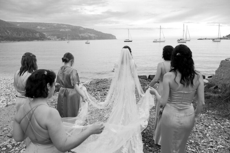 Bride and bridesmaids by the sea during a destination wedding in Mani
