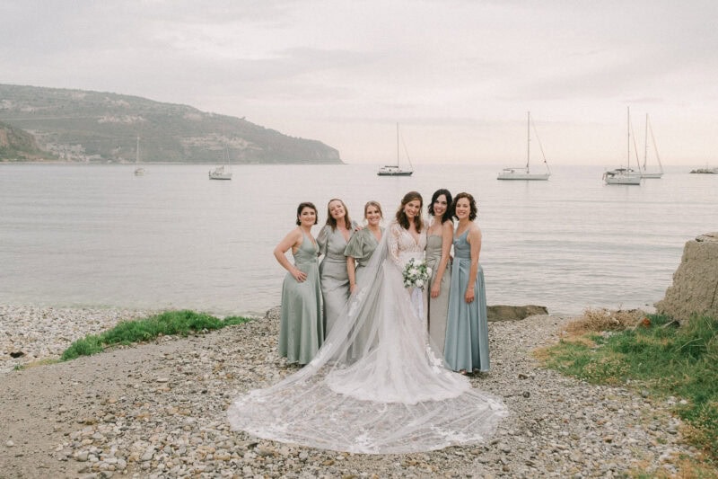 Bride and bridesmaids celebrating beside the sea in Mani