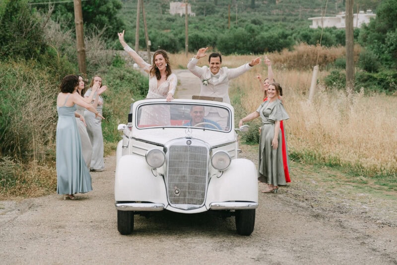 Bride and bridesmaids celebrating beside the sea in Mani