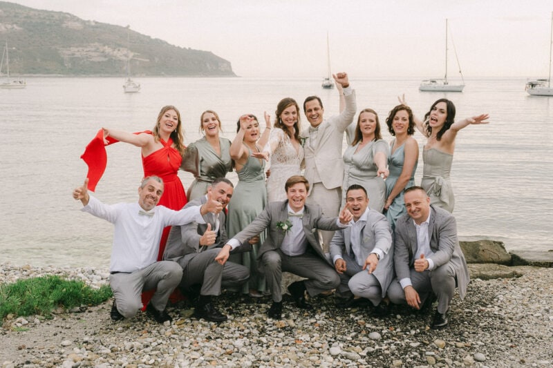 Bride groom and wedding party celebrating by the sea in Mani