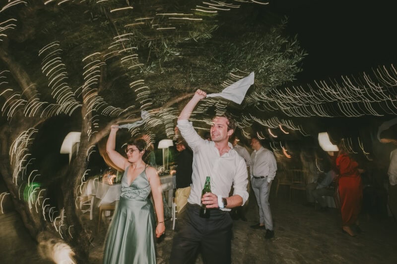 Guests celebrating on the dance floor at a destination wedding in Mani
