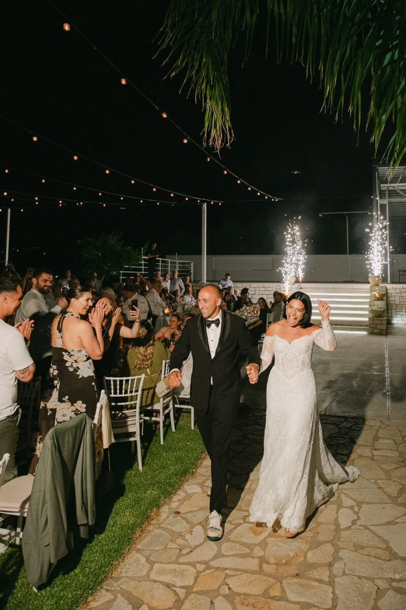 Spiros and Niki entering their wedding reception at Akrotiri Venue
