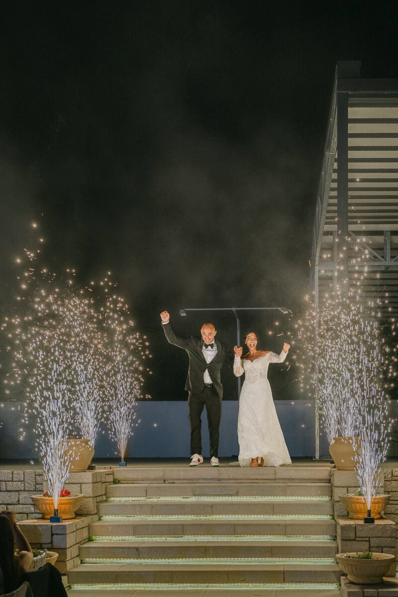 Spiros and Niki entering their wedding reception at Akrotiri Venue